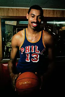 Wilt Chamberlain Standing by Trophy Display