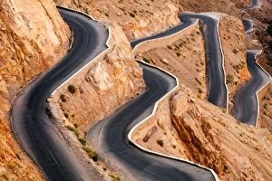 Winding road with hairpin bends up the rocky Atlas mountains from the Dades Valley, Morocco