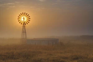Windmill Backlit at Sunrise in the Mist and Fog of a Cold Winter Morning, Free State Province, South Africa