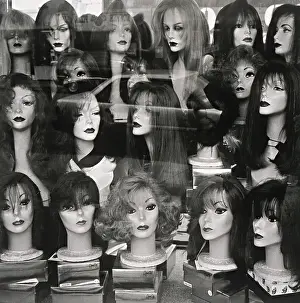 Human Likeness Prints: Window display of mannequin heads wearing assorted wigs