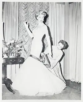 Woman Adjusting Sash on Ball Gown