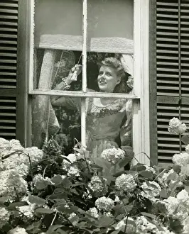 Blinds Prints: Woman adjusting widow blind, (B&W)