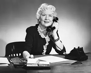 One Senior Woman Only Prints: Woman answering phone