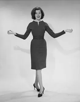 1960s Fashion Collection: Woman with arms outstretched, portrait
