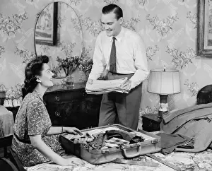 Wall Paper Prints: Woman assisting man packing suitcase (B&W)