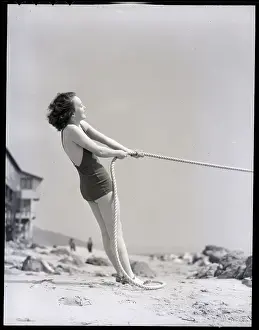 Woman in Bathing Suit Pulling Rope