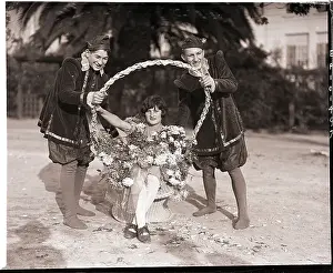 Woman in Bouquet, Pages Hold Basket