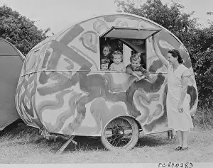 Secrecy Prints: Woman by Camouflaged Mobile Home with Children Inside