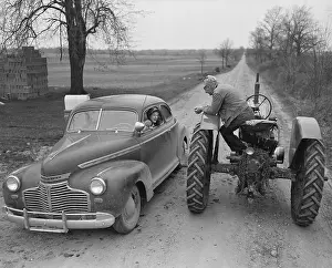 Woman in Car Talking to Man on Tractor