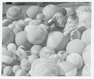 Woman and Child Observing Beach Balls