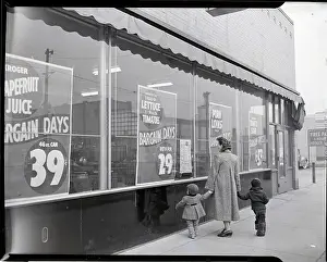 Woman and Children Look at Grocery Window