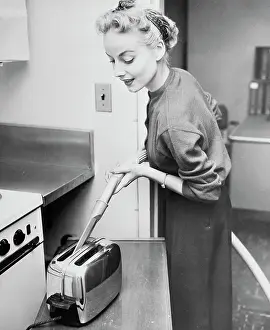 Toaster Prints: Woman Cleaning Toaster with Vacuum Cleaner