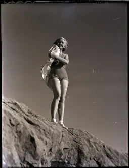 Woman on Coastal Rock with Her Scarf