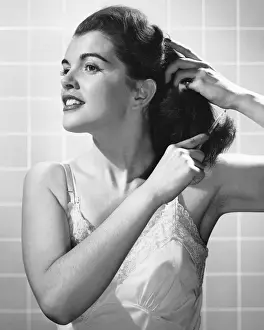 Woman combing hair