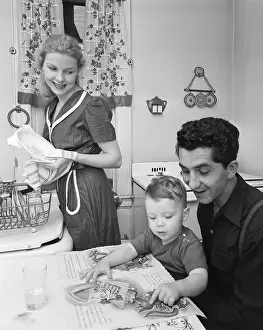 Martial Arts Uniform Prints: Woman Cookiing While Man Reads To Son