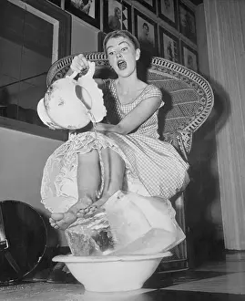 Woman Cooling Her Feet with Ice and Water