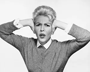 Woman covering ears with hands