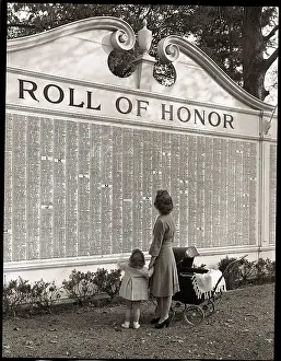 Woman and Daughter Looking at Honor Roll Wall