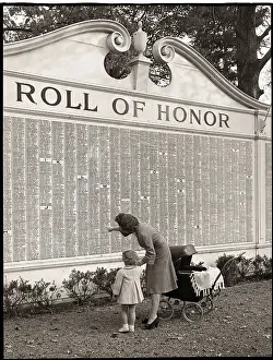 Woman and Daughter at Roll of Honor Wall