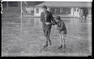 Woman and Daughter Skating on Ice