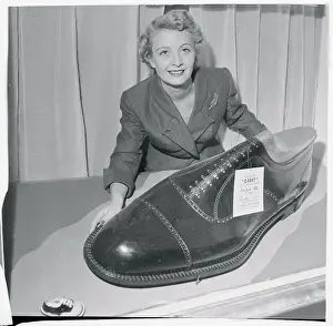 Woman Displaying Oversized Novelty Shoe