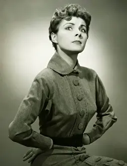 Woman with displeased expression posing in studio, (B&W), portrait