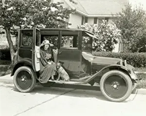 Driveway Prints: Woman And Dog Seated On A Dodge Outside