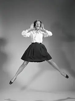 Blouse Prints: Woman doing cheerleader jump, hand up to mouth, yelling and screaming