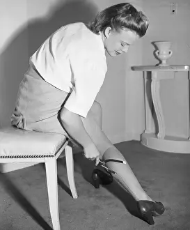 Repairing Prints: Woman Drawing False Stockings on Her Leg