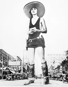 Cowgirl Prints: Woman Dressed in Cowgirl Costume with a Gun