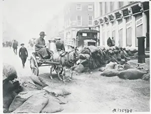 Woman Driving Cart near Bag Strewn Street