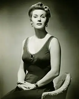 Attitude Prints: Woman in evening dress posing in studio, (B&W), portrait