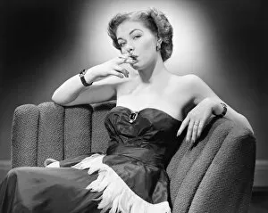 Corsetry Gallery: Woman in evening dress smoking cigarette (B&W), portrait