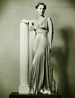 Dressing Up Prints: Woman in evening gown posing by column, (B&W), portrait