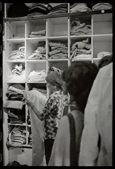Woman Examining Pants in Store