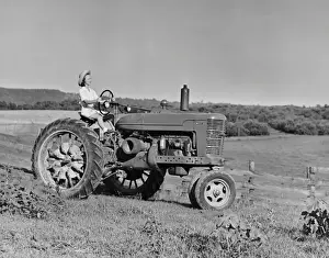 Woman farmer driving tractor