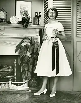 Graduation Prints: Woman in fashionable dress posing at fireplace, (B&W), (Portrait)