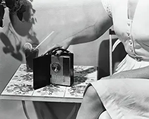 Displaying Prints: Woman with First Hand Held Personal Radio