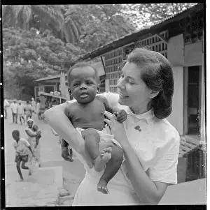 Woman as Foreign Caretaker Holding Child
