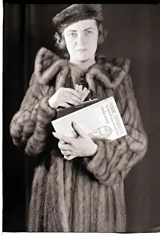 Woman in Fur Coat Holding Tickets