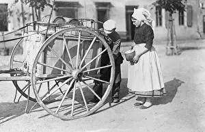 Woman Getting Milk from Milkman in Street