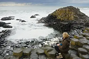 Boot Prints: Woman in the Giants Causeway - North Ireland - United Kingdom