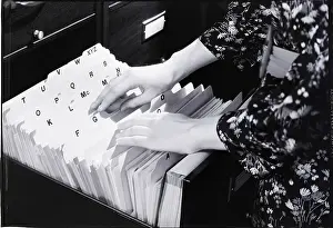 Searching Prints: Woman Going Through Files
