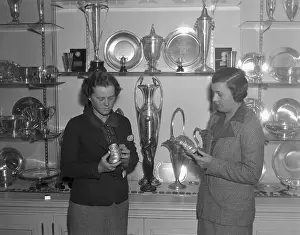 Woman Golfers Looking at Trophies