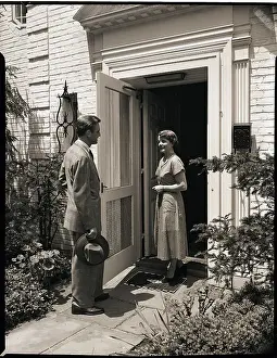 Woman Greeting Man at Door