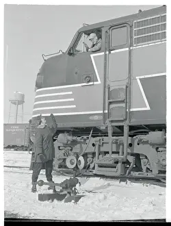 Woman on Ground Greeting Train Engineer
