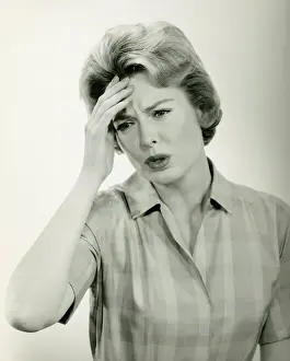 Worried Prints: Woman with headache, posing in studio, (B&W) (Portrait)