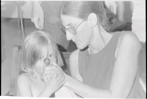Ann Arbor Prints: Woman Helping Young Child Smoke Pipe