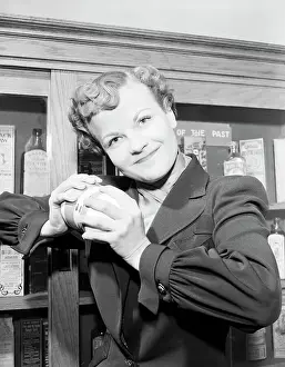 Woman Holding An Atom-Expanding Device