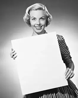 Woman holding blank paper